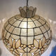 Large mother-of-pearl and brass chandelier with floral decoration.