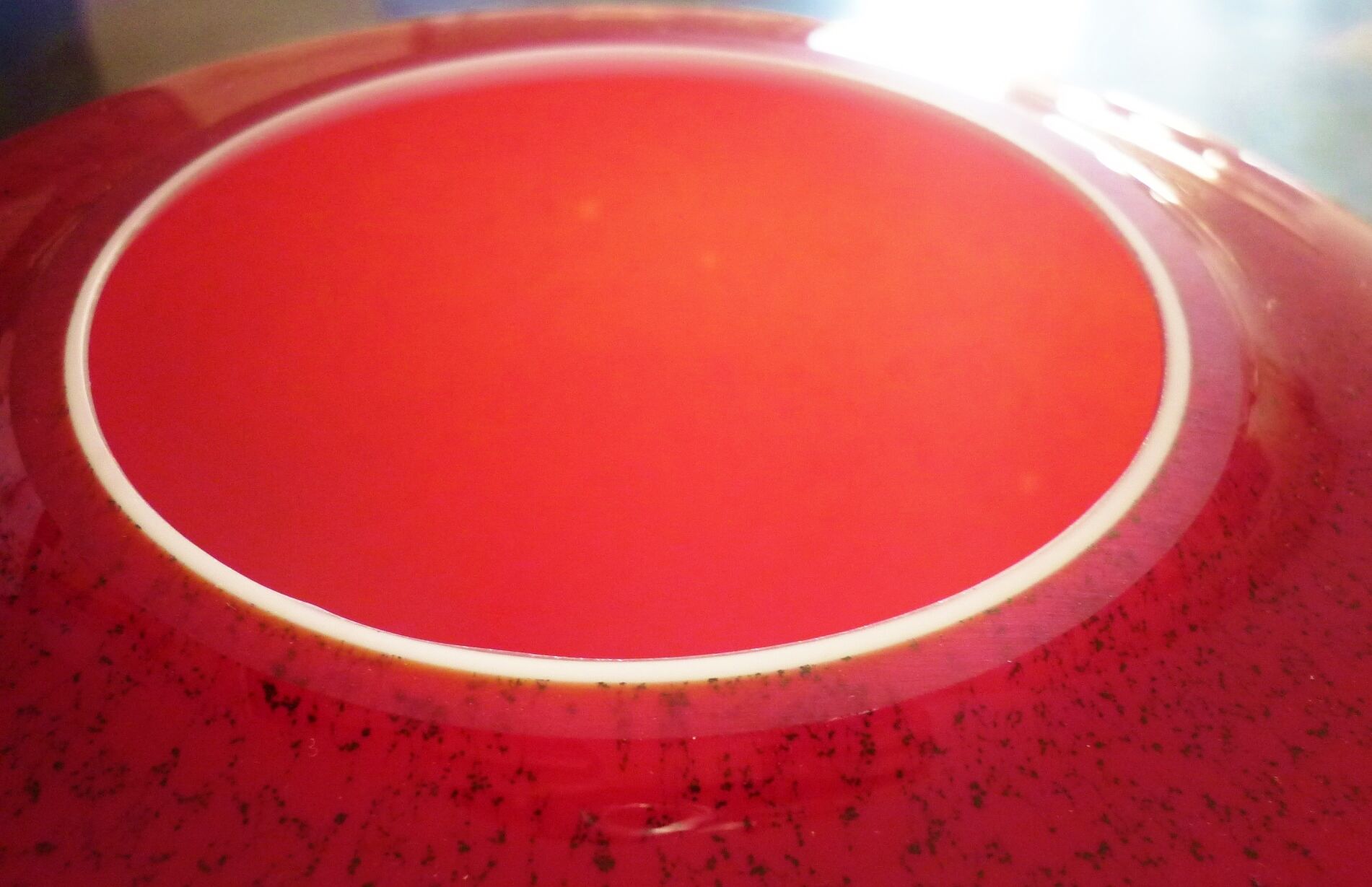 Pot-bellied, art deco vase in speckled ruby red multi-layered glass, white interior