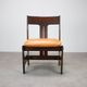 Vintage German sculptural chair from the 1970s in wood with orange faux leather.