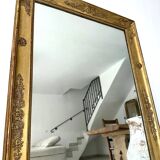 Antique gilded mirror from the Restoration period, 19th century.