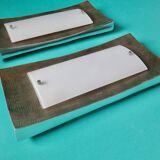 Pair of wall sconces in gold-plated alloy with bas-relief and opaline glass. Germany, 1980