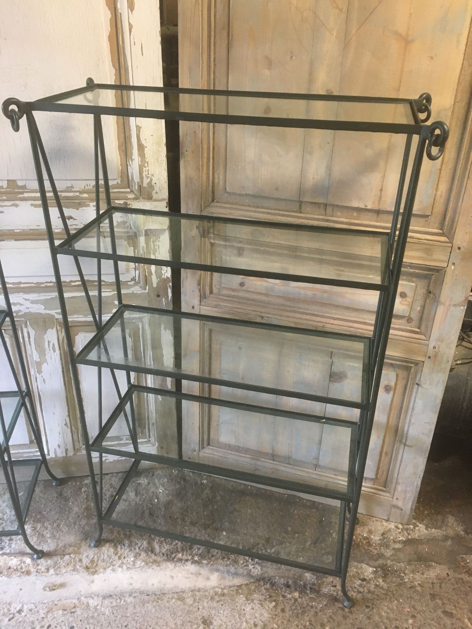 Pair of wrought iron and glass bookshelf shelves.