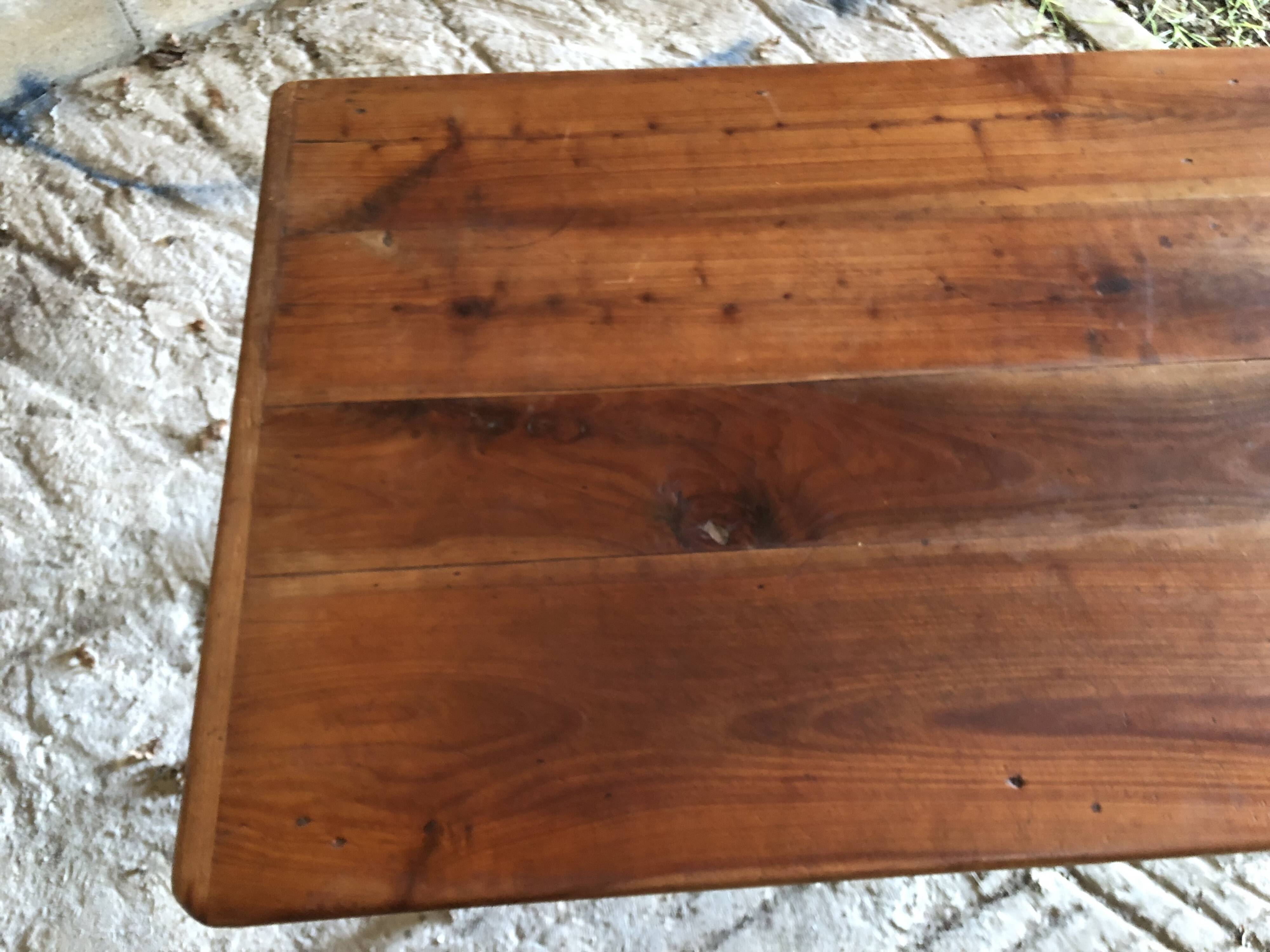 Antique Louis Philippe style farm table in solid cherry wood with turned base.