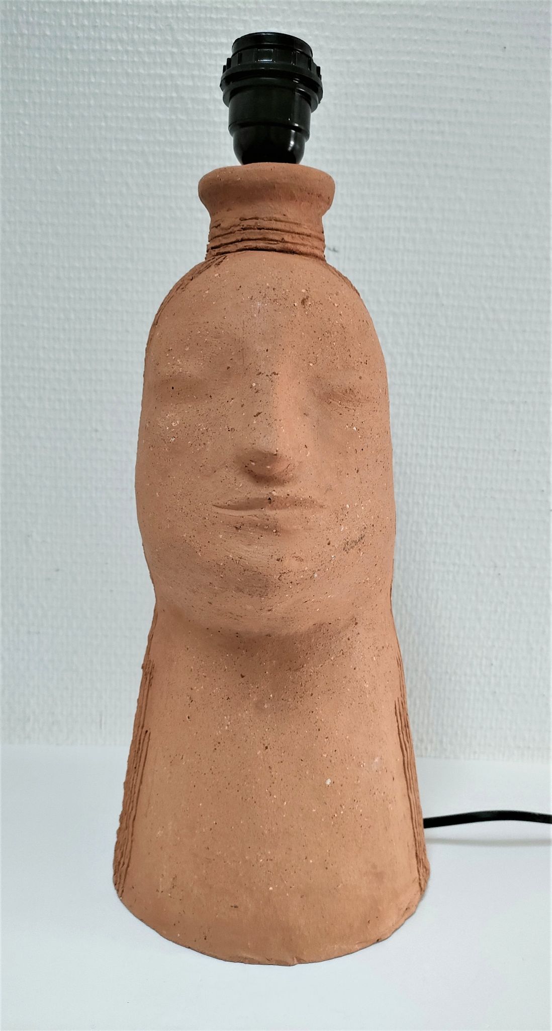 Anthropomorphic lamp foot depicting two faces terracotta design 80s