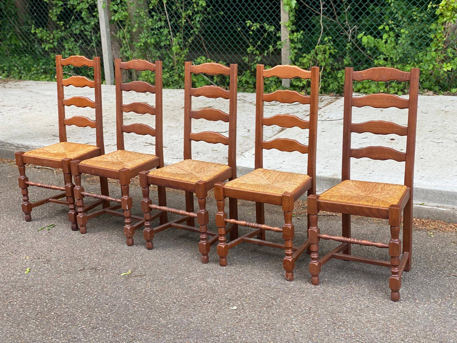 4 or 5 solid wood chairs with light oak straw and high backs