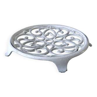 Vintage white cast iron trivet from the early 20th century