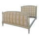Louis XVI style bed richly decorated in patinated wood.