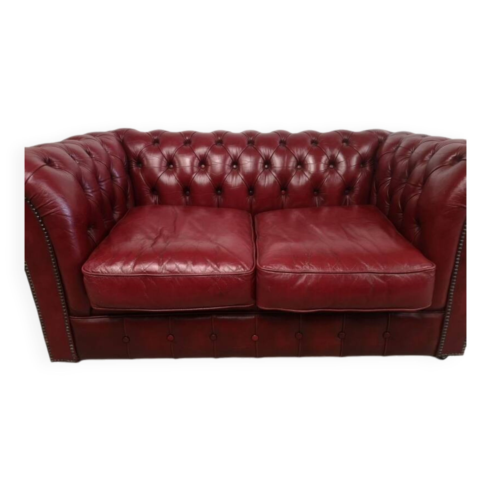 Red two-seater chesterfield sofa