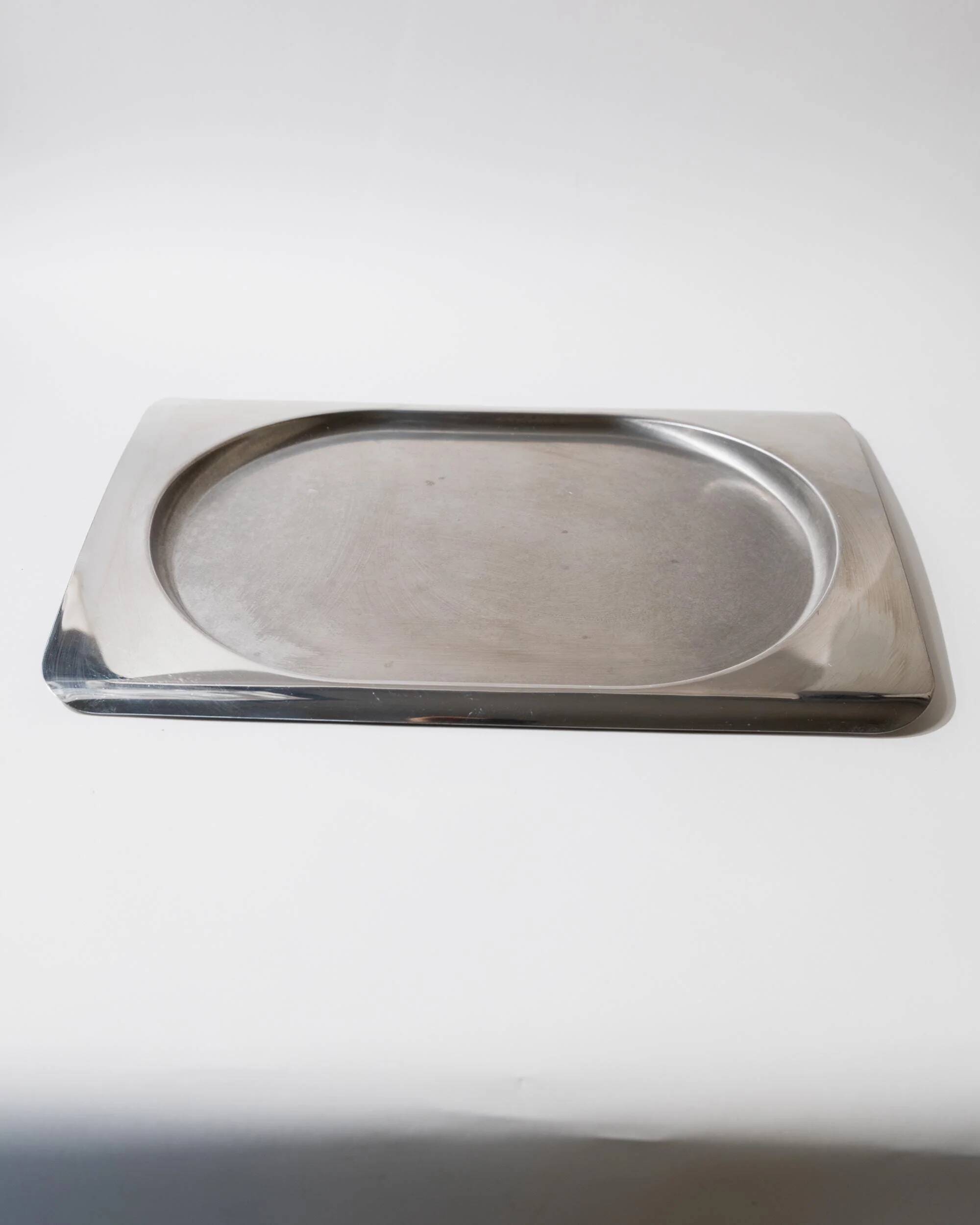 1990s vintage stainless steel platter, rectangular with an oval indentation, minimalist modern design.