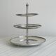 Vintage three-tiered serving stand in patinated silver metal.