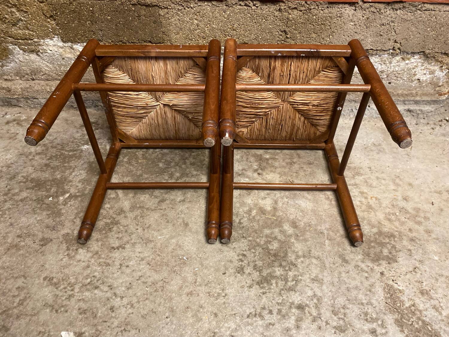 Pair of vintage wooden stools with woven straw seats