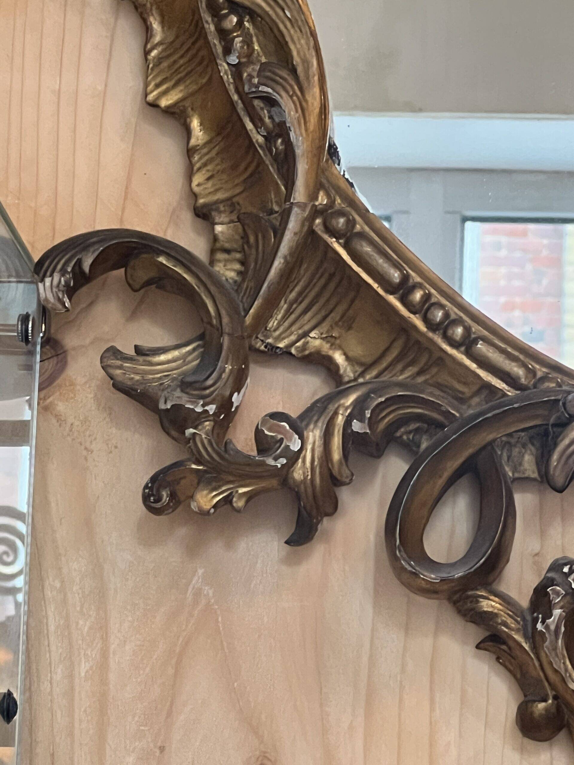 Large gilded wooden mirror, richly carved with winged dragons, 19th century