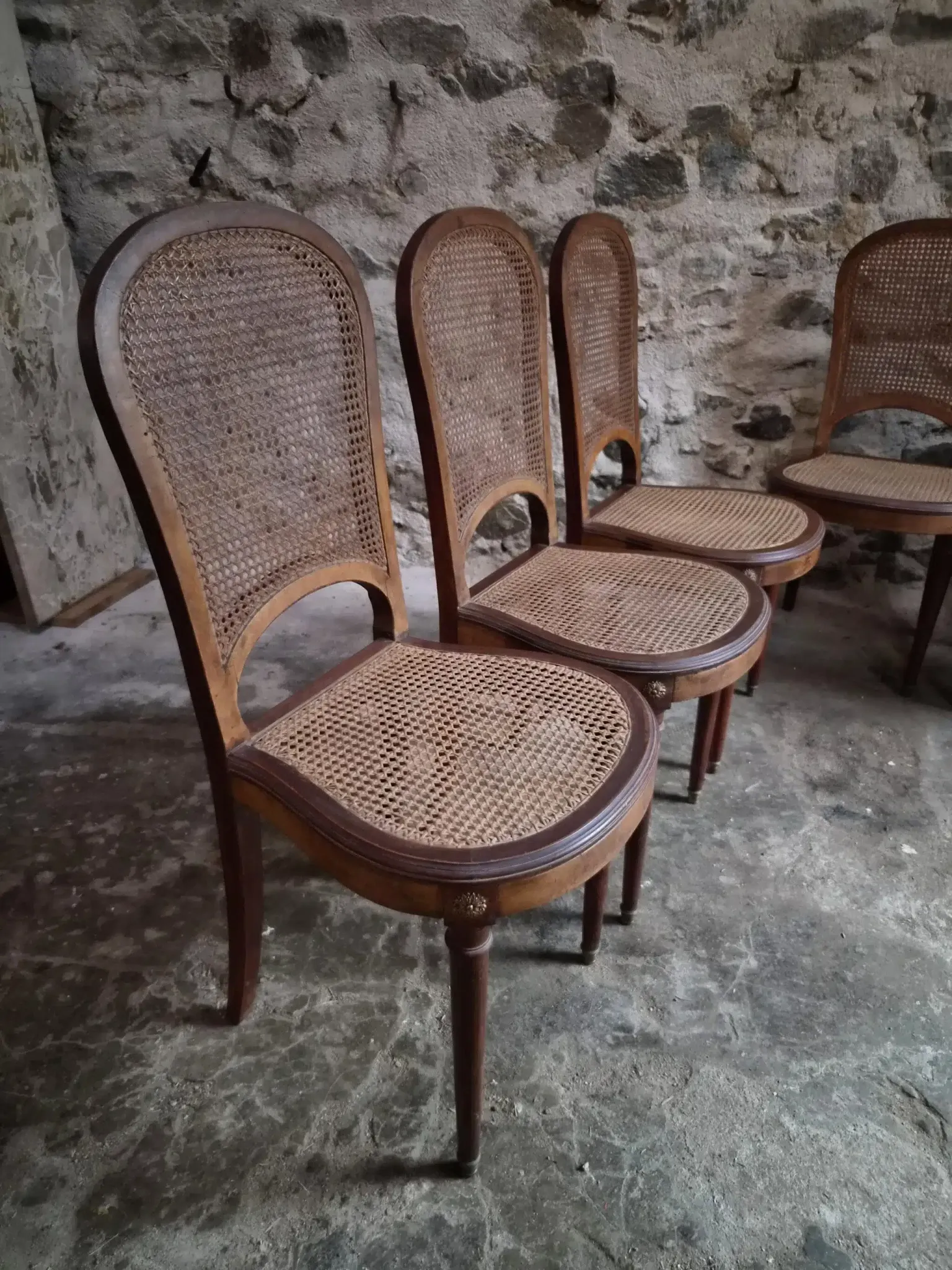 Set of 6 antique Louis XVI style dining chairs with caning.