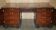 Partner desk with two carved columns featuring lion heads, according to Thomas Chippendale, restored.