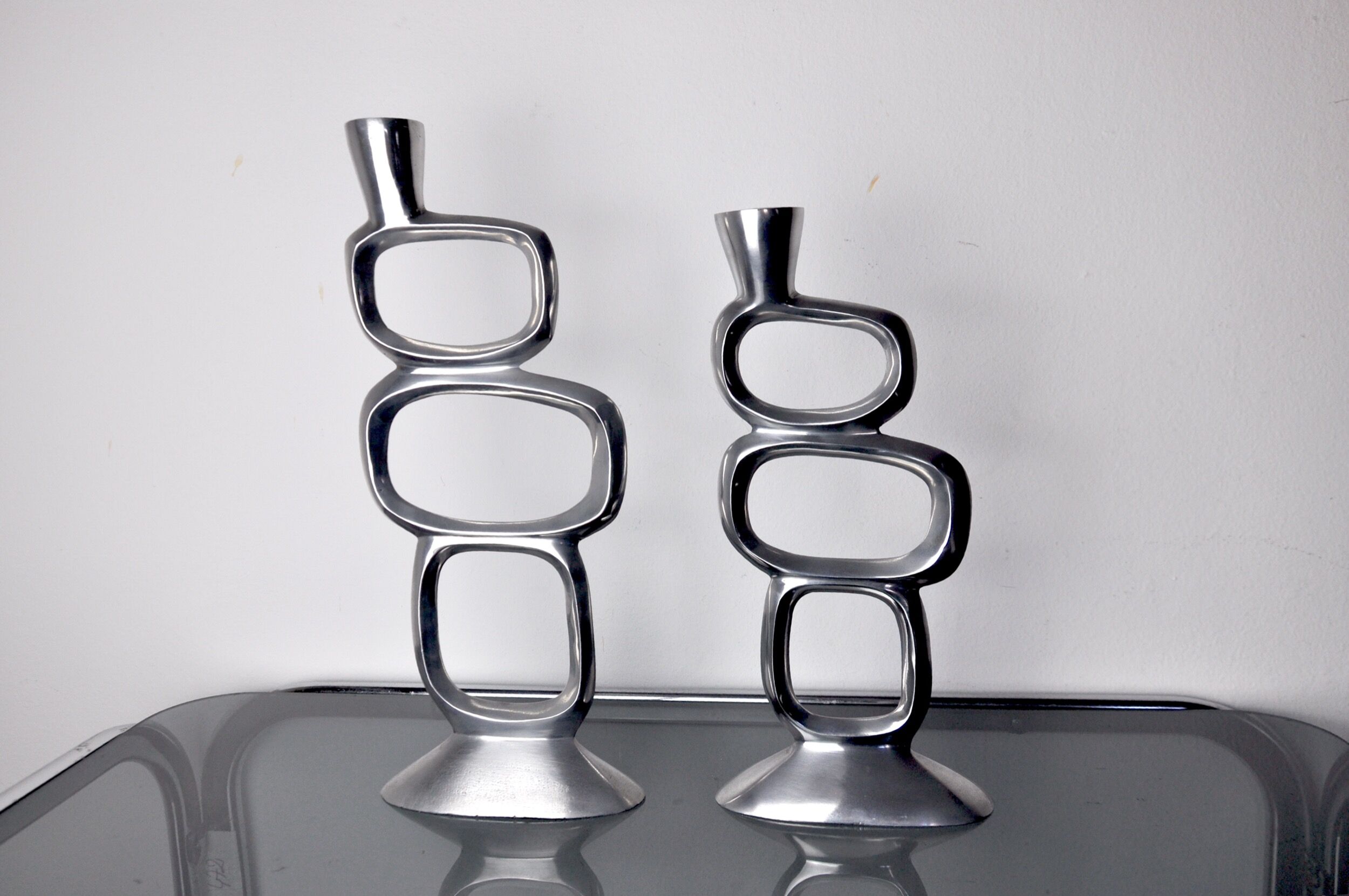 Pair of circle candlesticks by matthew hilton, england, 1980