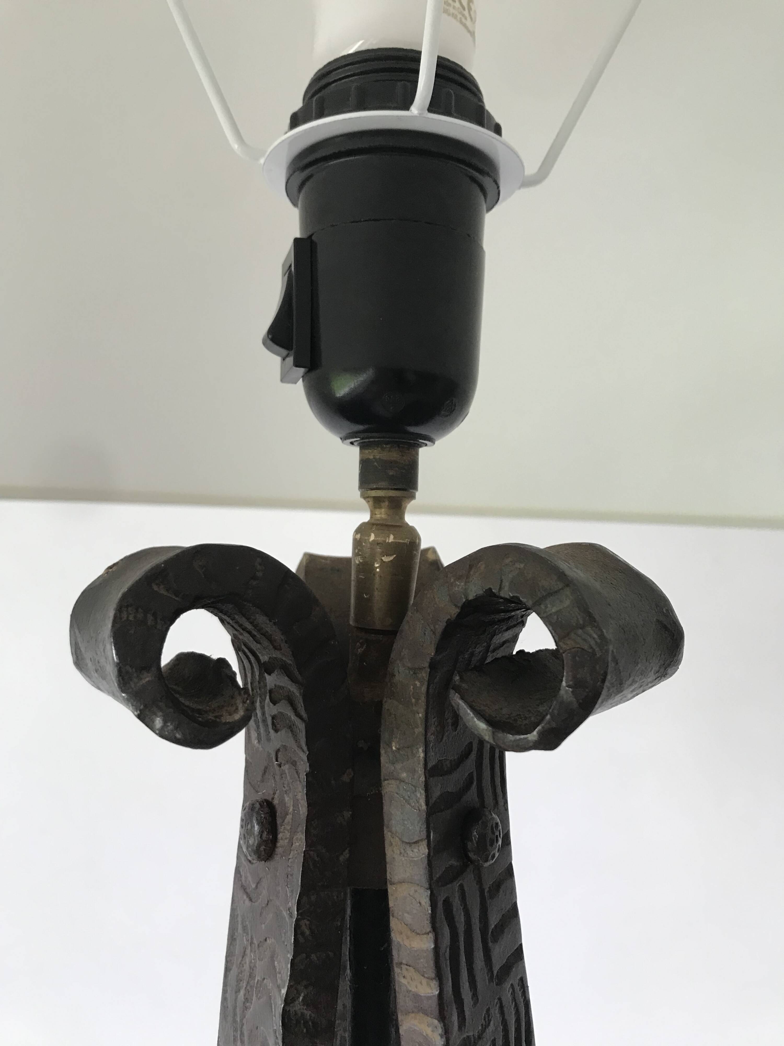 Art deco wrought iron floor lamp decorated with flowers, circa 1930.