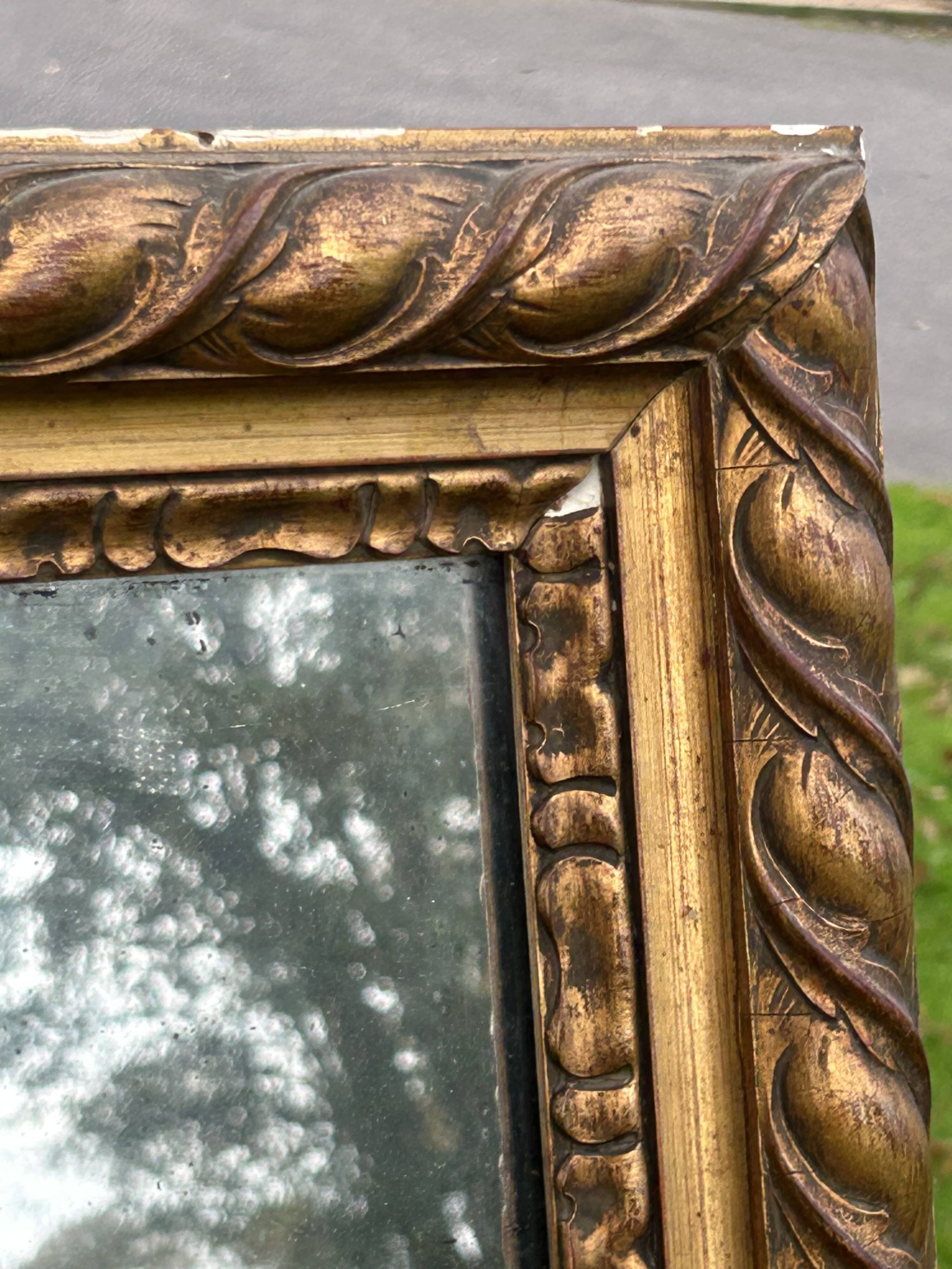 Large antique gilded mirror, wood and stucco gadroons, partially de-mercury
