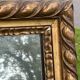 Large antique gilded mirror, wood and stucco gadroons, partially de-mercury