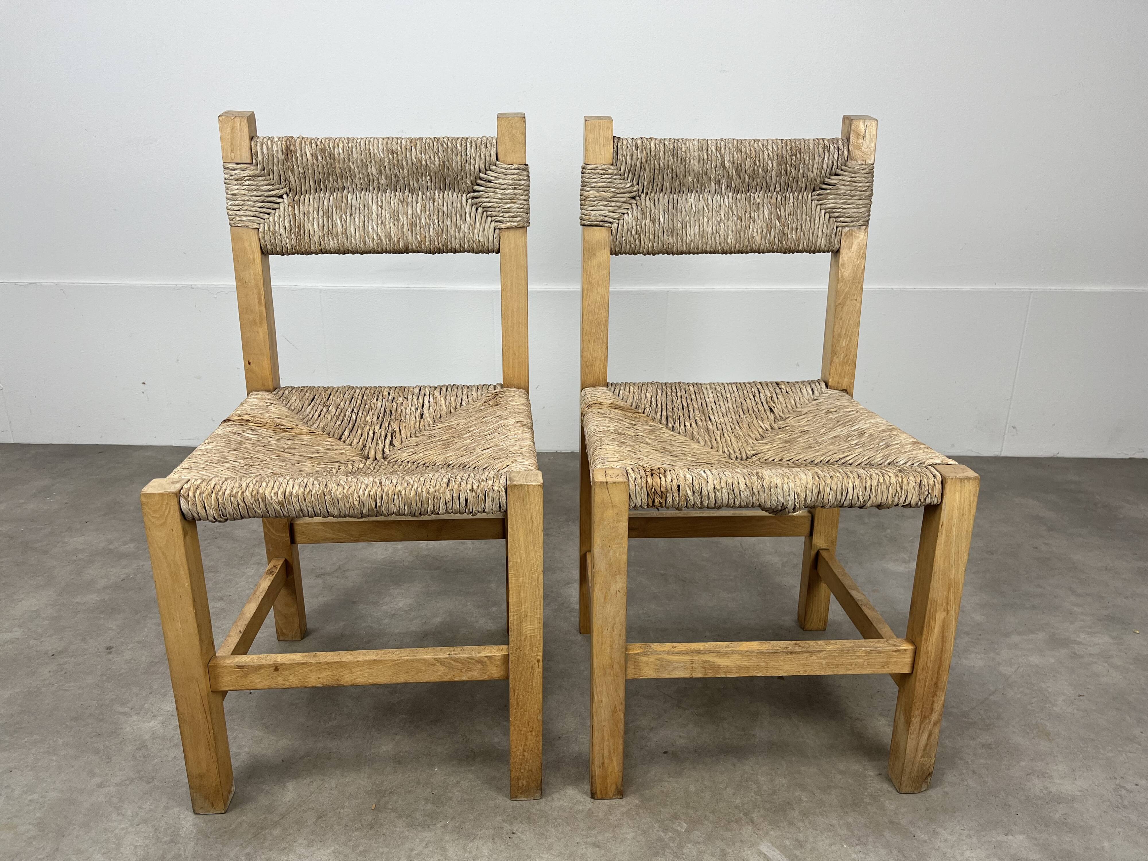 2 straw and wood chairs in brutalist style