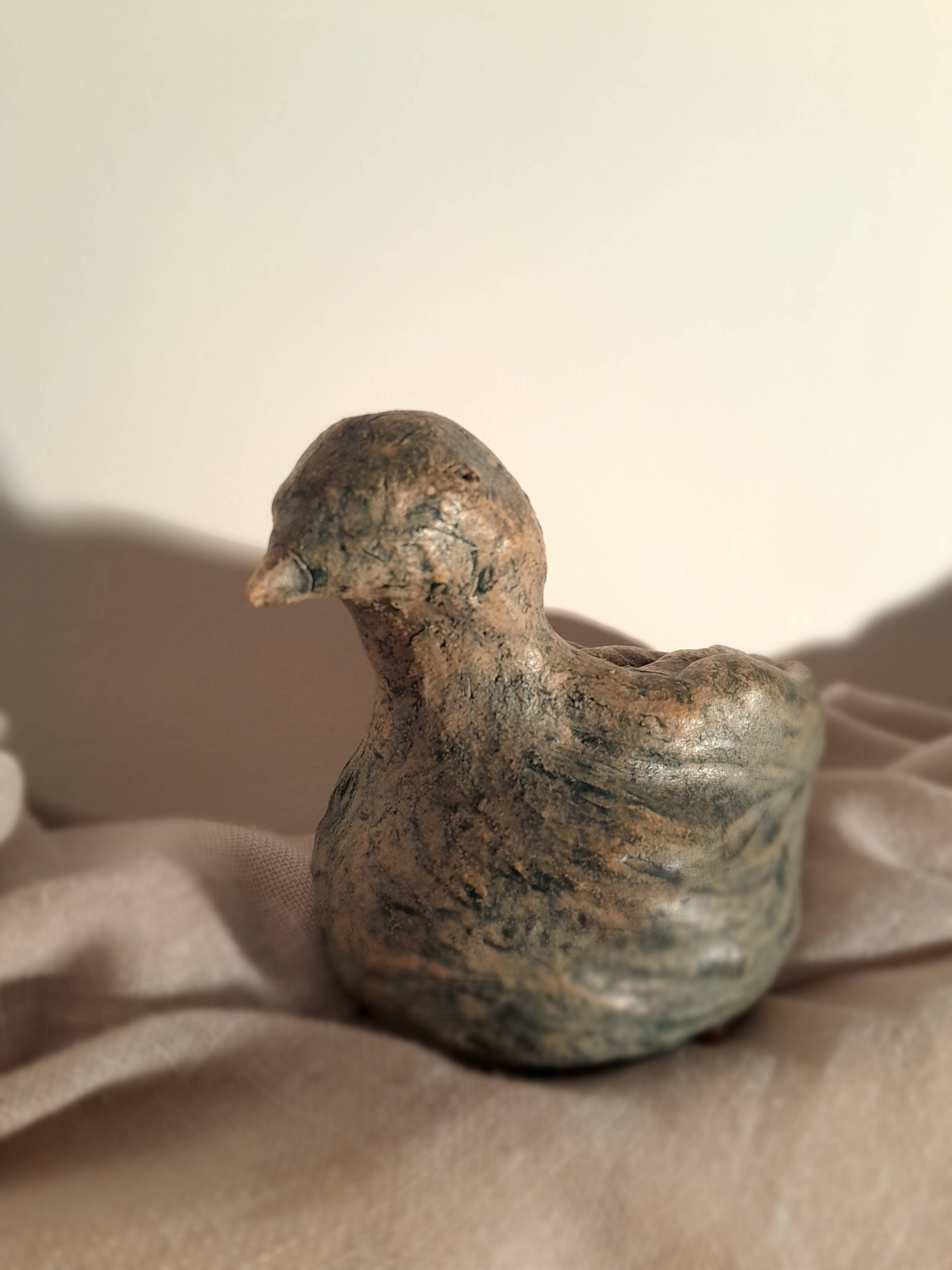 Signed bird sculpture