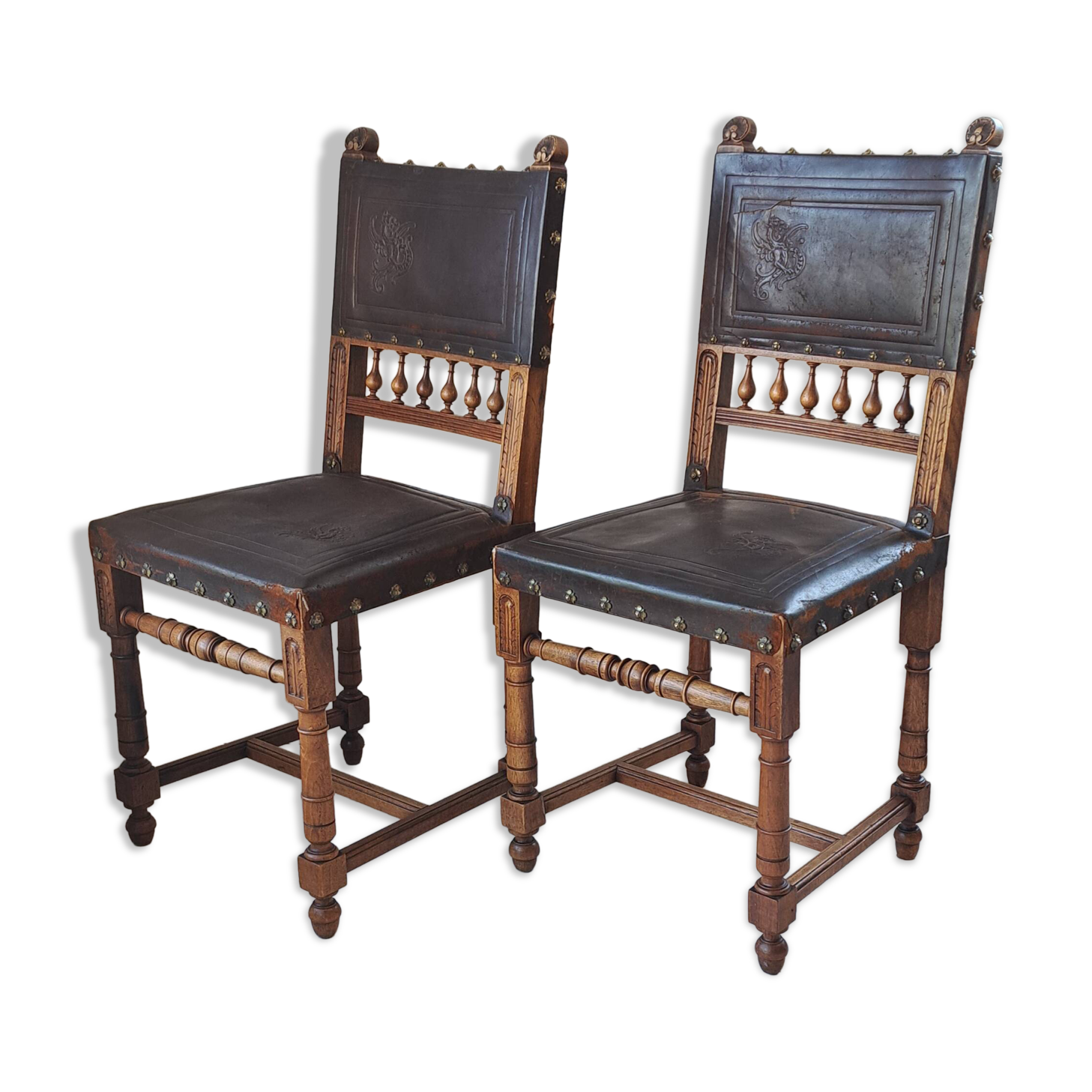 Pair of antique chairs in embossed leather, Henri II style.