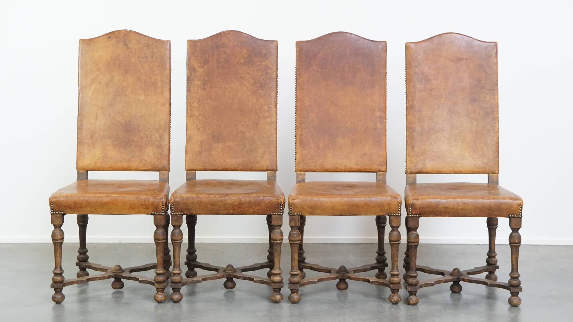 Set of 4 antique wooden and sheepskin leather dining chairs