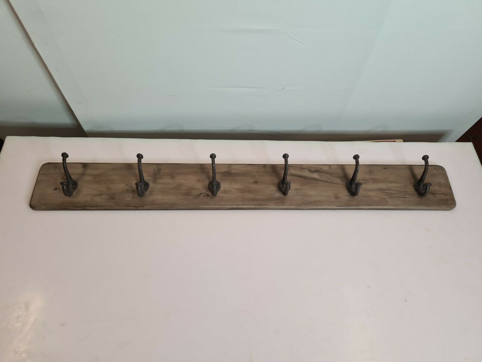 wooden school coat rack and iron hooks