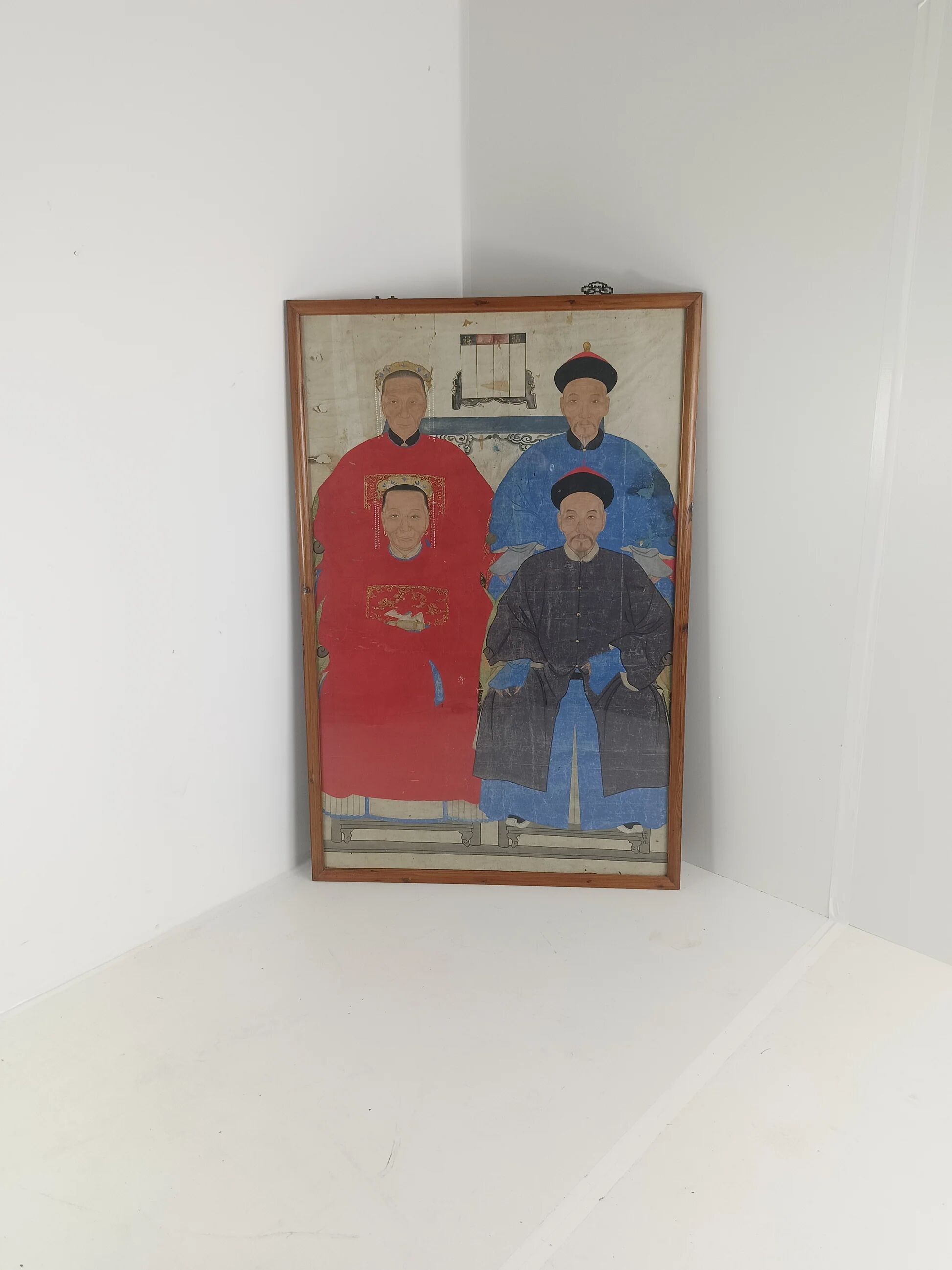 A framed Chinese ancestral portrait is a traditional hand-painted