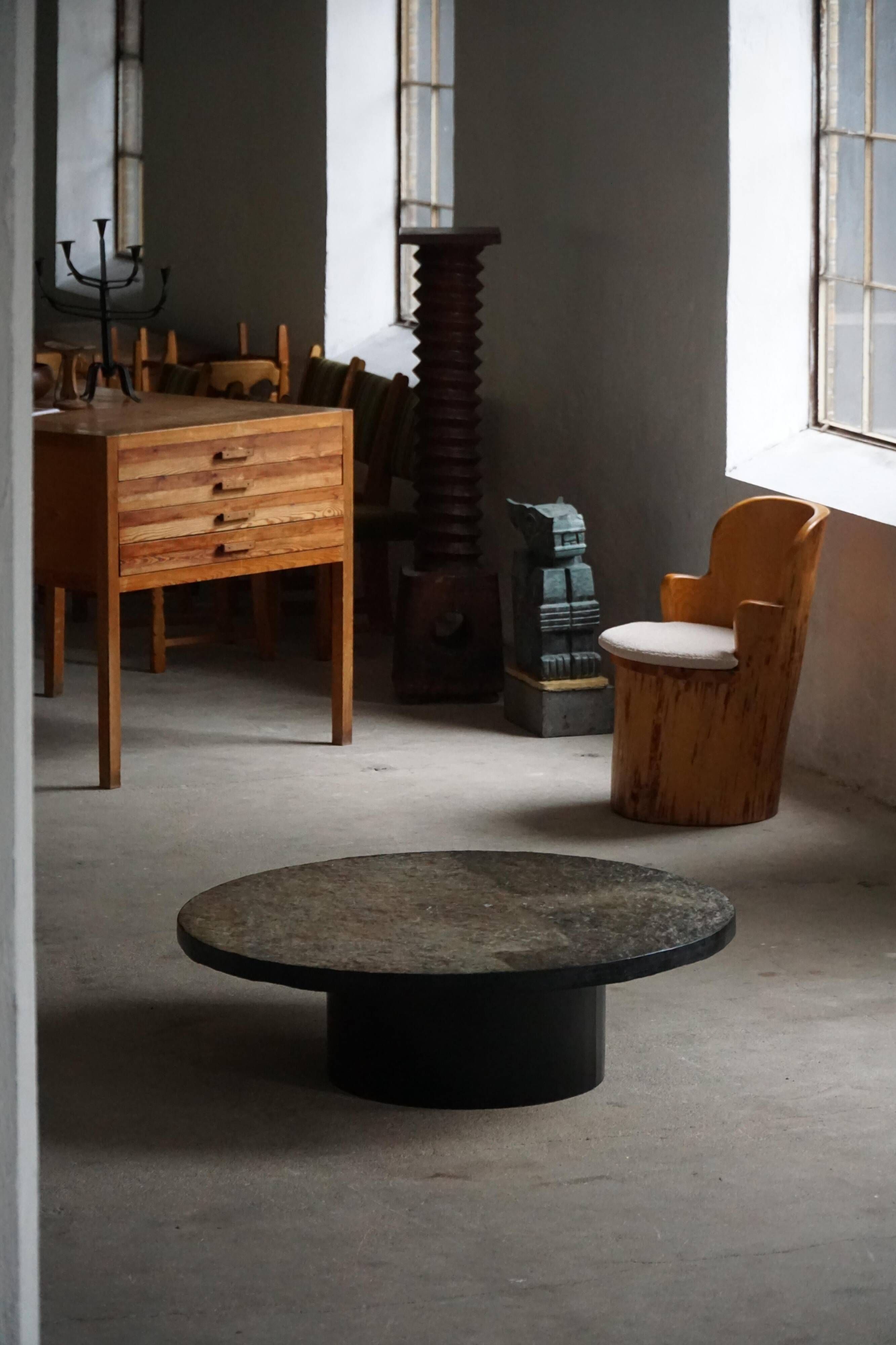 Round brutalist coffee table in stone and steel, mid-century French modernism, 1970s.