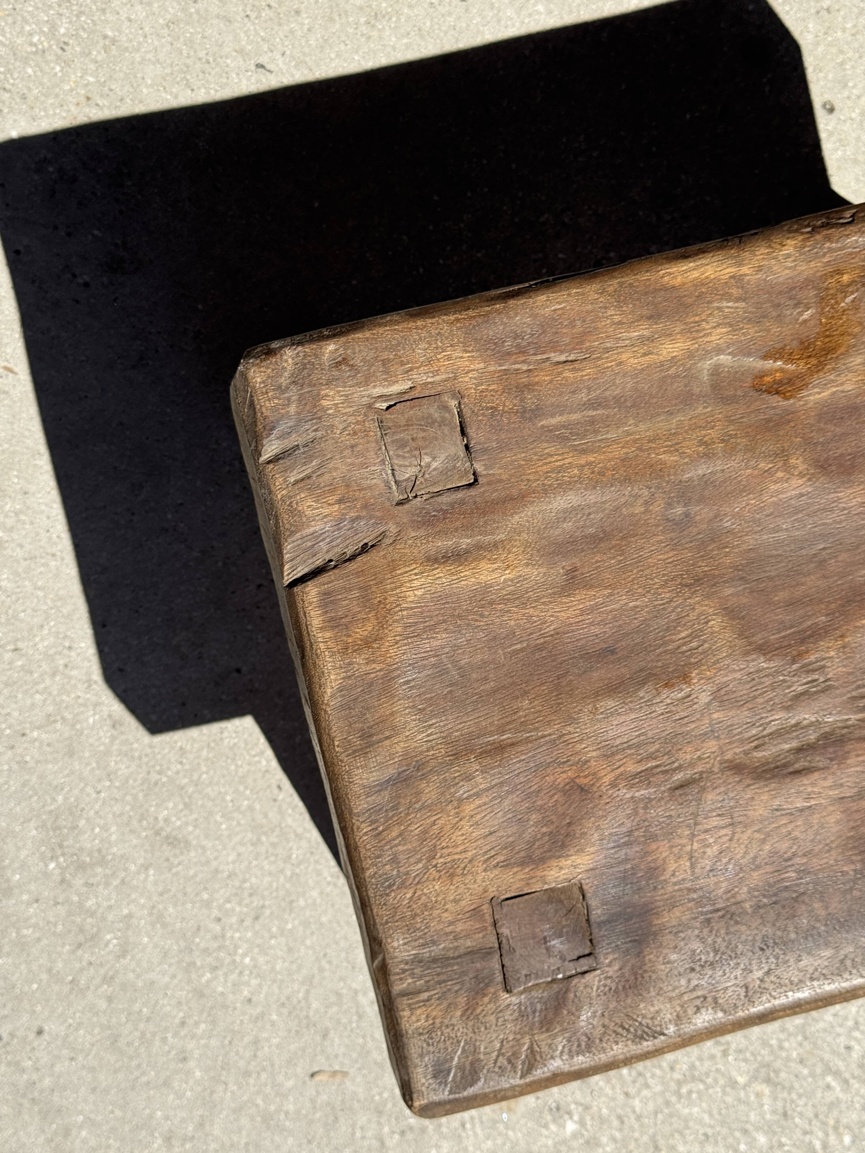 Small stool, rectangular solid teak side table with curved legs.