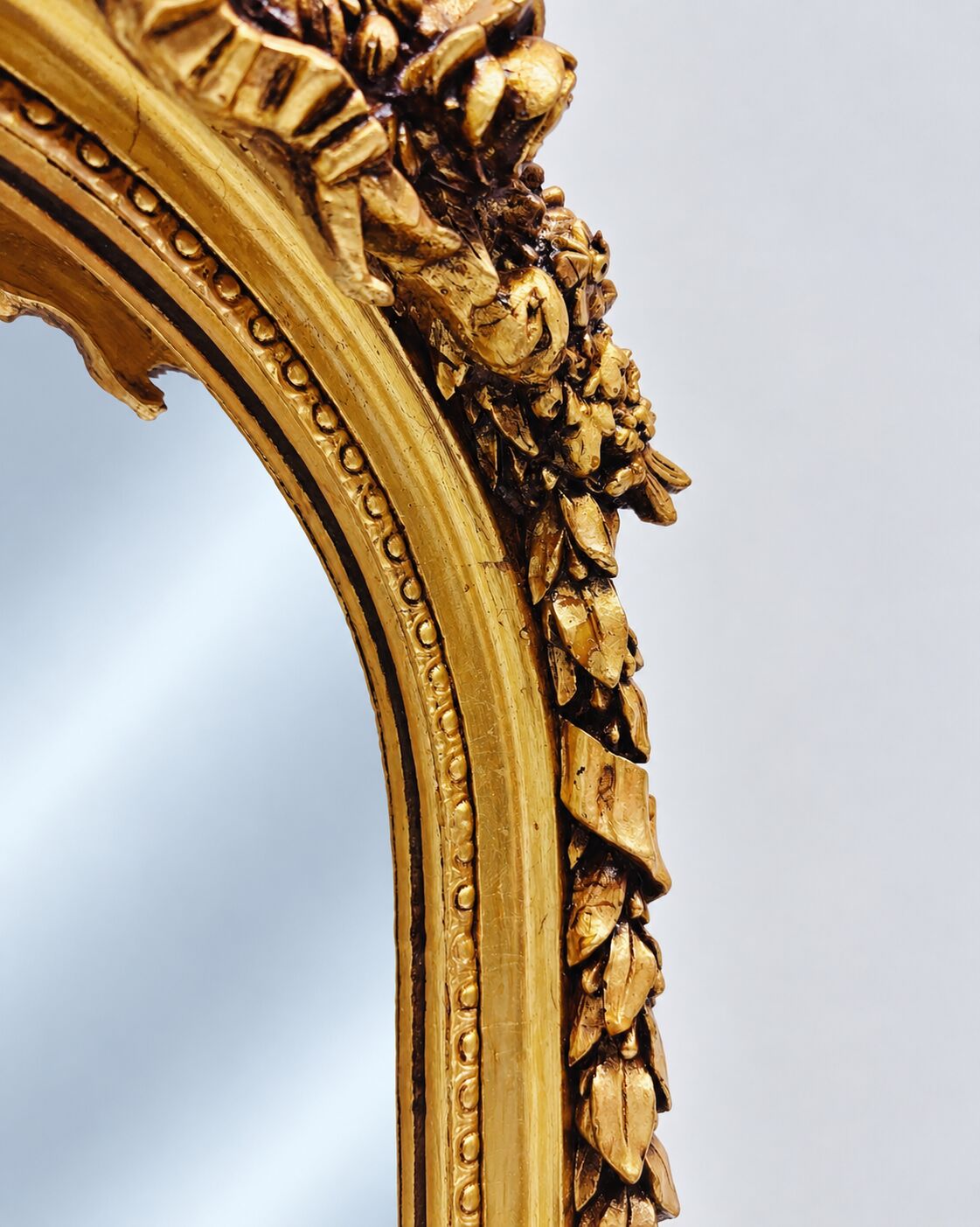 Large gold full-length mirror with ornate crest