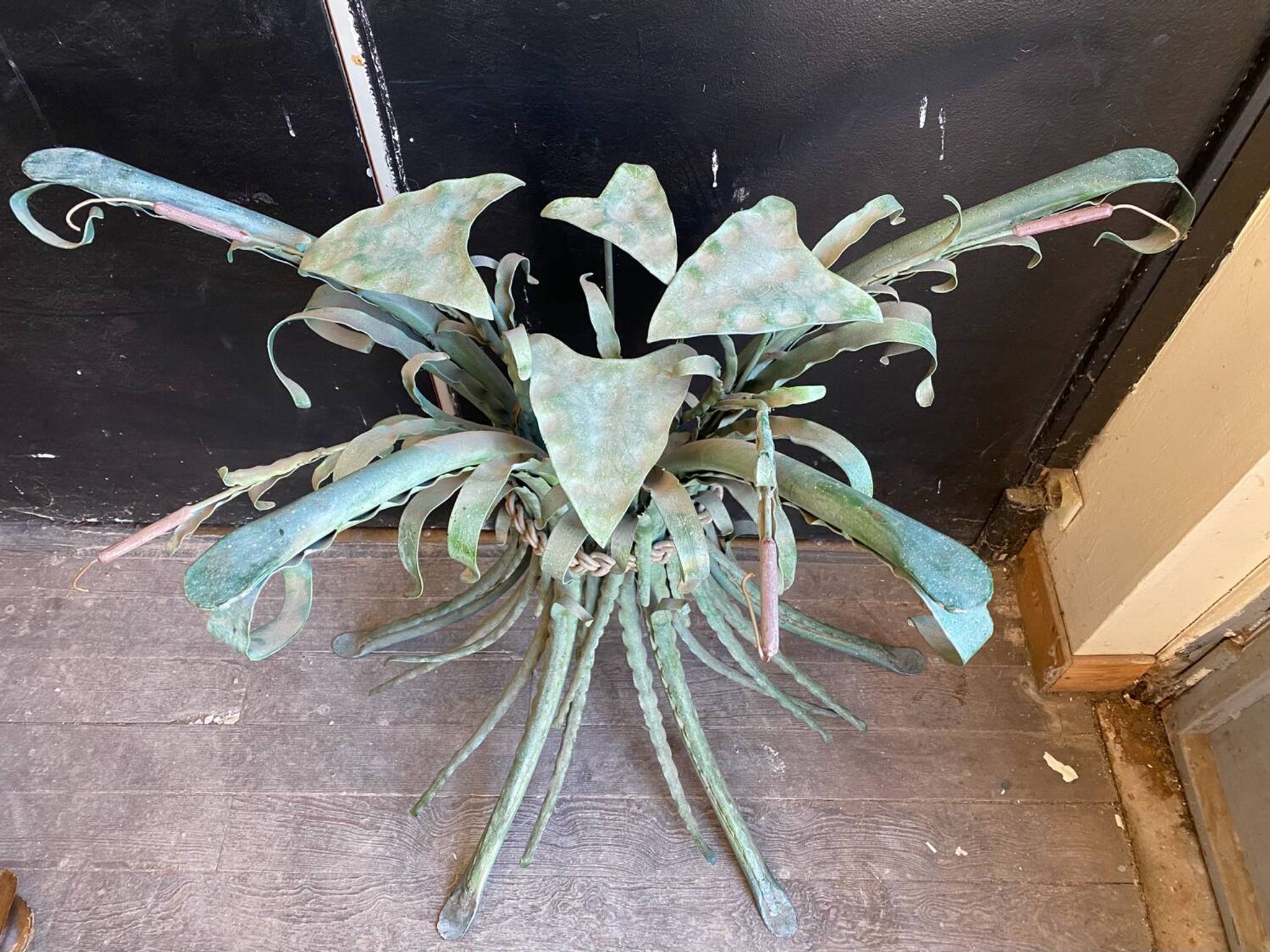 Vintage console in patinated metal with reed leaves.