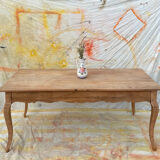 Curved farmhouse table in rustic wood, Provençal style.