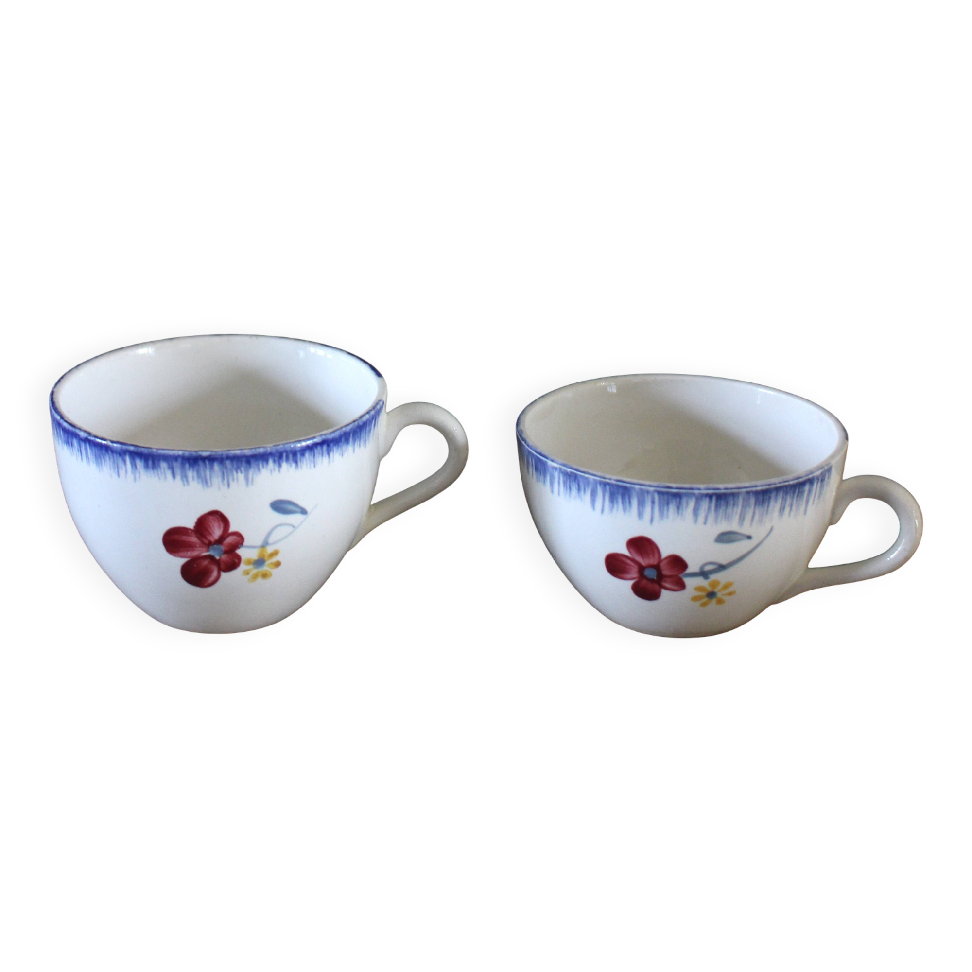 A set of two Digoin earthenware cups with blue, red, and yellow flowers.