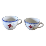 A set of two Digoin earthenware cups with blue, red, and yellow flowers.