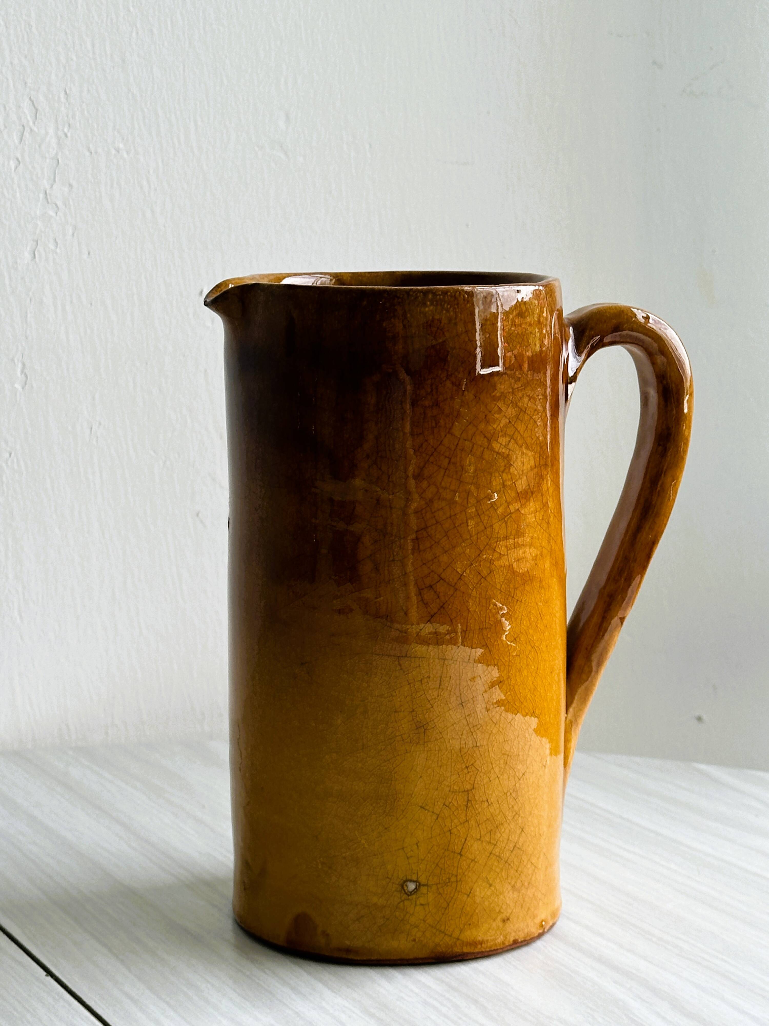 Vintage enameled ceramic watering can vase - retro mustard yellow pot.