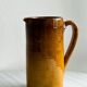 Vintage enameled ceramic watering can vase - retro mustard yellow pot.