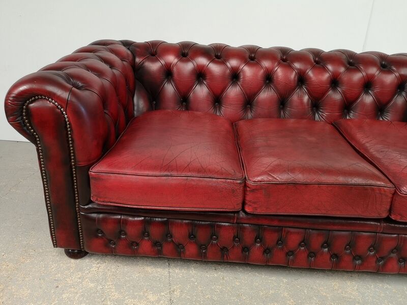 Three-seater red leather chesterfield sofa