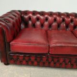 Three-seater red leather chesterfield sofa