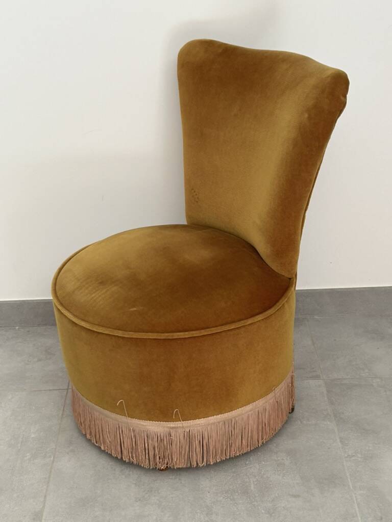 Ochre and fringed pouffe-style armchair