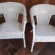 2 white wicker armchairs