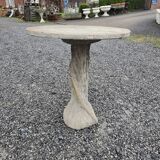 Cement garden table with trunk-shaped foot