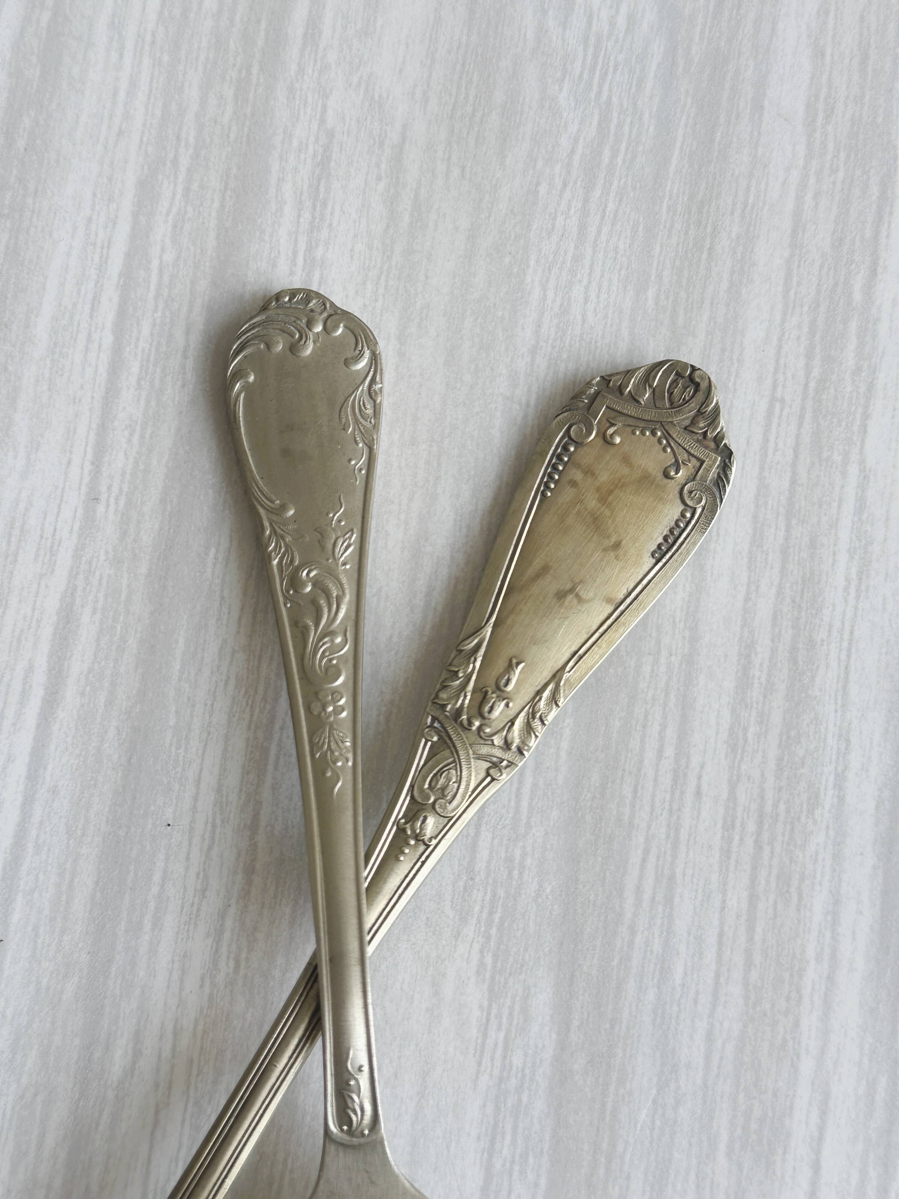 Pair of metal forks, ornate design