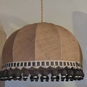 Large hanging pendant light with a burlap and pom-pom style