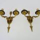 Pair of double-light Empire style arrow wall lights in bronze. Early 20th century