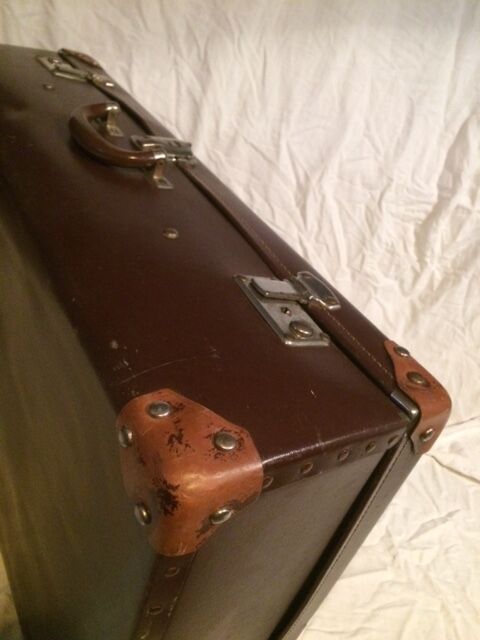 Suitcase vintage leather inside and brown carpeted home