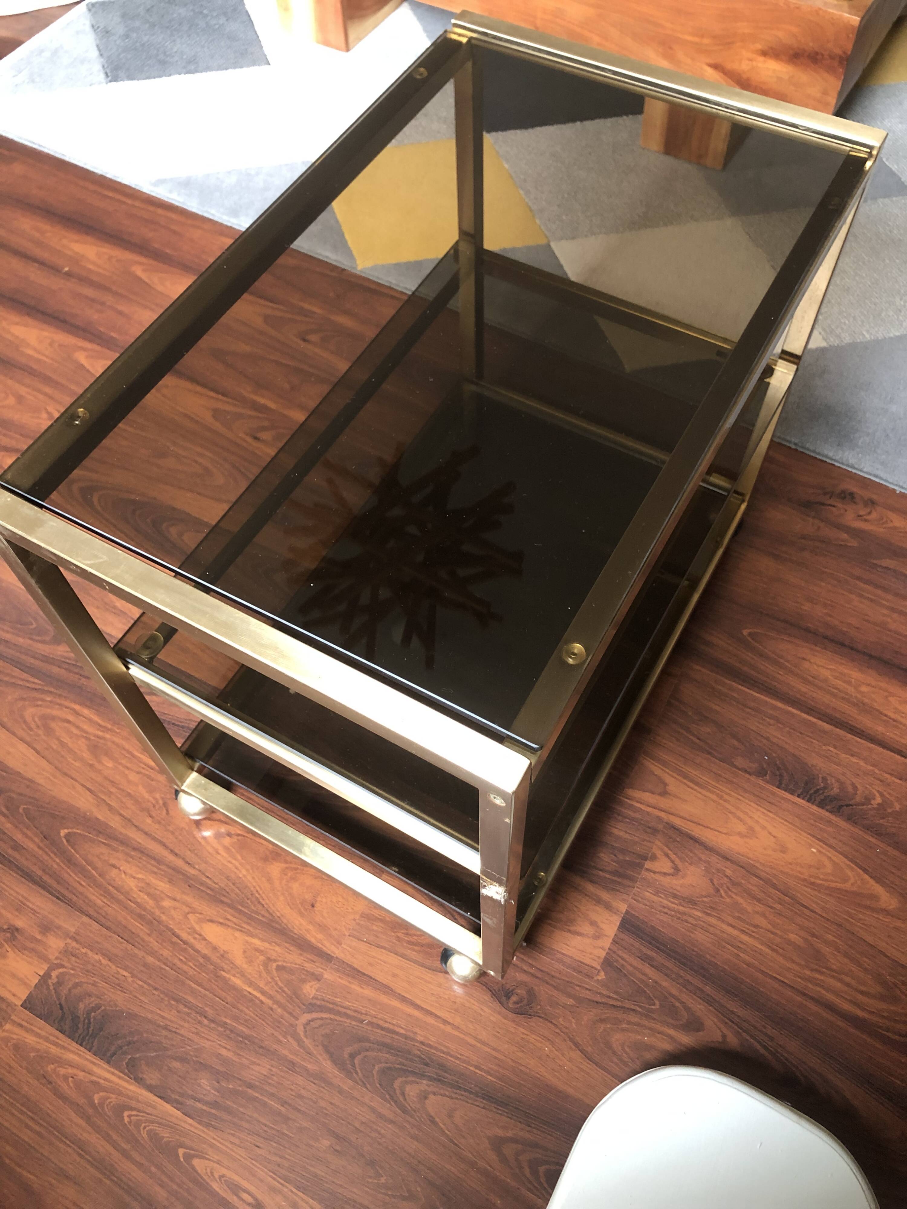 Vintage brass serving trolley with smoked glass trays.