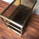 Vintage brass serving trolley with smoked glass trays.
