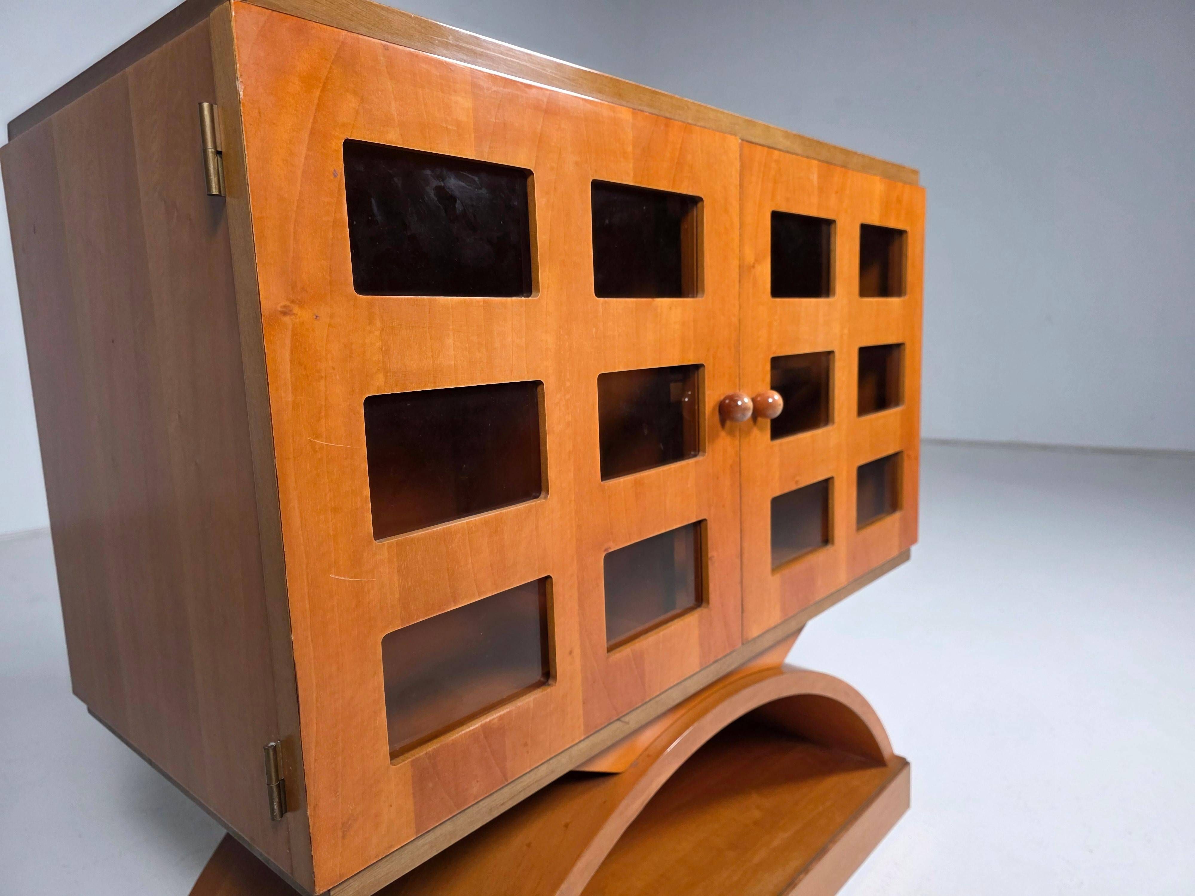 Mid-century modern mobile bar cabinet with sculptural base, 1950s.