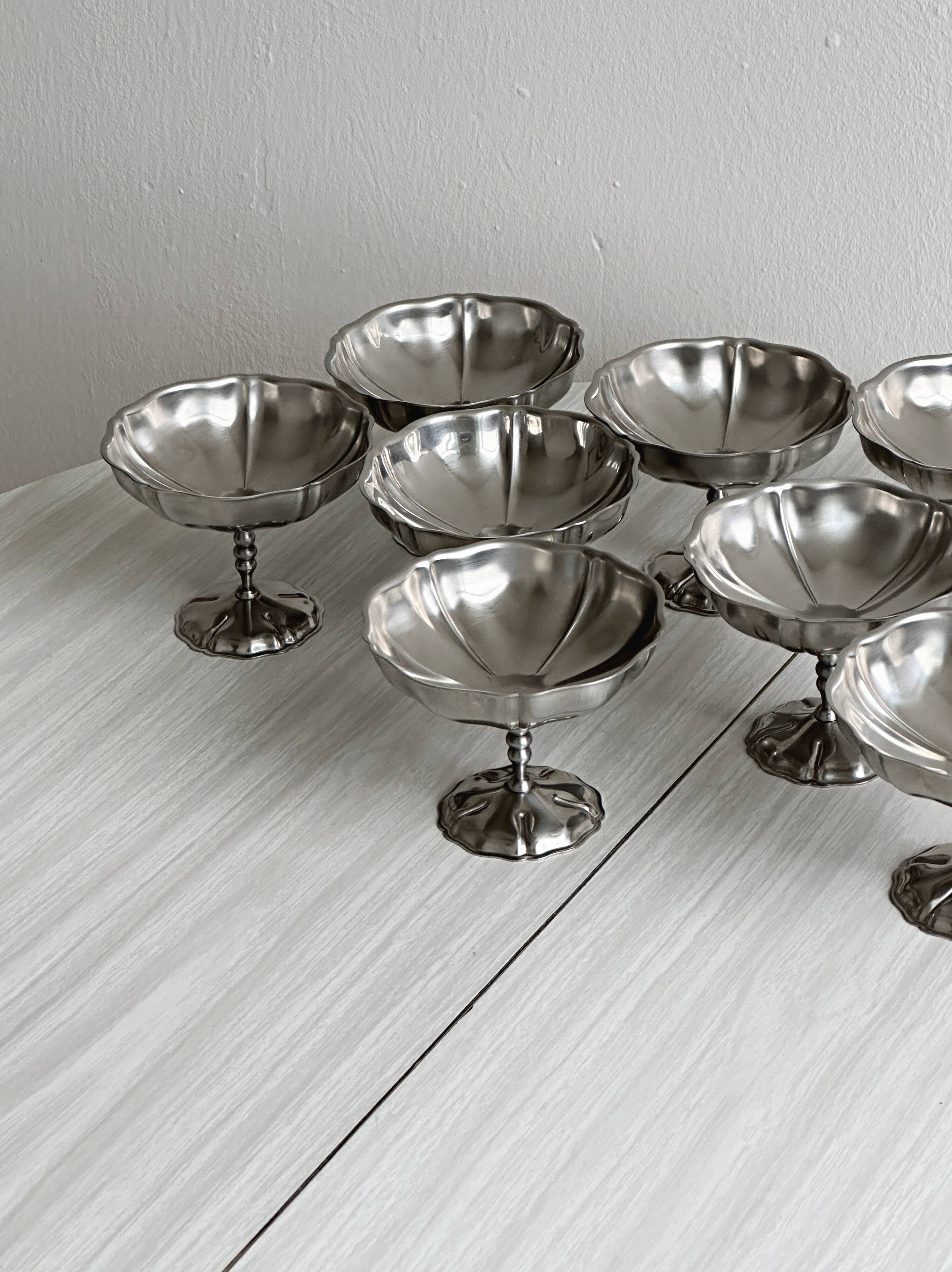 8 very large stainless steel footed bowls